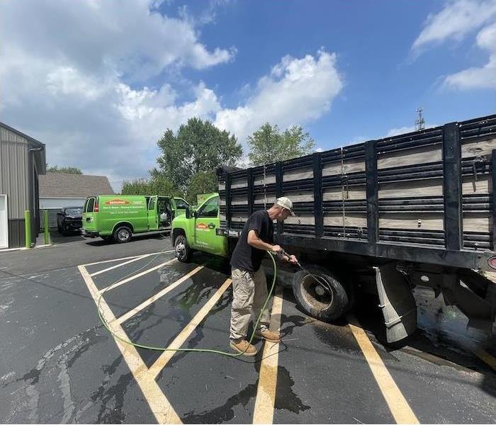 SERVPRO technician power washing a SERVPRO truck